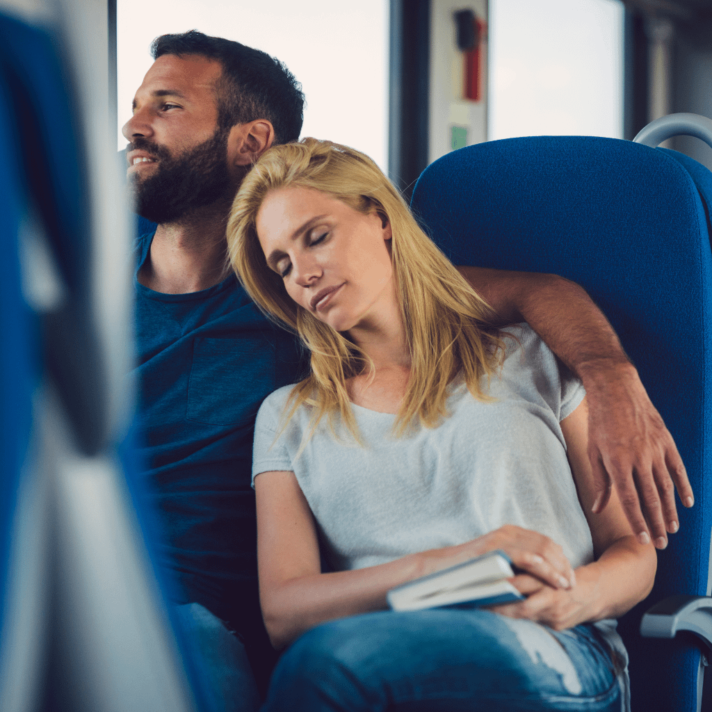 A couple resting on the train journey